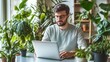 © WS Studio 1985 - Man Working on Laptop Surrounded by Indoor Plants