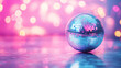 © malik - Shiny disco ball on table against blurred background, toned in pink. Space for text