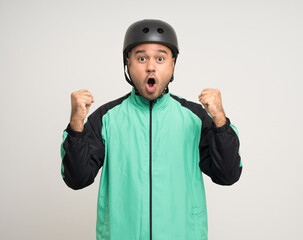 Young asian rider wearing green jacket uniform and bike helmet standing various action on isolated white background. Male delivery service worker. Delivery courier and shipping food service.