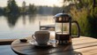 © ISK PRODUCTION - Cozy lakeside setting with a French press coffee maker and cup on a wooden table, comfortable chair with cushions