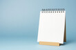 © ekampos - A blank desk calendar on a light blue background