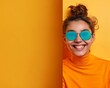 © Qstock - Bright, Vibrant Portrait of a Smiling Woman in Blue Sunglasses and Orange Turtleneck Against Yellow Background - Happy and Stylish Lifestyle