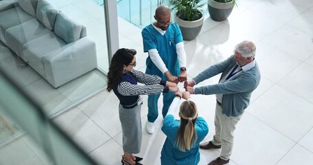 Wall Mural - People, doctors and fist bump in lobby at clinic with support, motivation or above for health services. Hospital director, staff and team in scrum for meeting with cheers, celebration and diversity