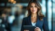 © designtoday - Confident Businesswoman Holding Tablet in Modern Office