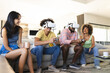 © Wavebreak Media - Playing video games with VR headsets, diverse friends enjoying time together on couch, at home
