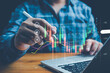 © pornnipa - Businessmen investor think before buying stock market investment using smartphone to analyze trading data. trader is showing a growing virtual hologram stock on smartphone. Financial stock market.