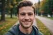 © ThomasLENNE - Close portrait of a smiling young Canadian man looking at the camera, Canadian outdoors blurred background