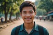 © ThomasLENNE - Close portrait of a smiling young Lao man looking at the camera, Lao outdoors blurred background