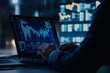 © Jiraphat - A professional analyzing data on a laptop with stock market graphs at night, demonstrating finance and technology synergy.