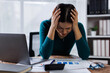 © David - Young woman working on laptop having headache. Bored workaholic female accountant employee with headache and stress. Businesswoman woman with migraine, stress relief, chronic pain