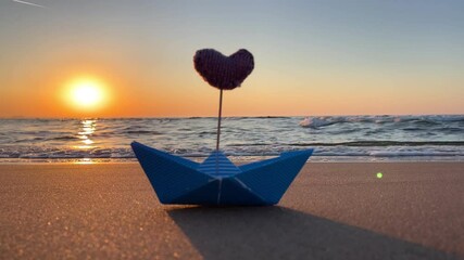 Poster - blue boat with pink heart on the beach at sunset