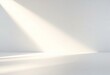 © NipaArts - White wall with soft light streaks and shadow.