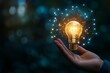 © mohdfaizal - Illuminating Idea: A Hand Holds a Glowing Lightbulb