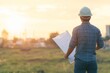 © mohdfaizal - Architect Examining Blueprint at Sunset
