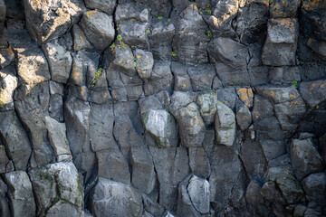 Natural structures and shapes from Iceland. Beautiful natural scenery for the background. Rock wall texture. Granite, basalt, gneiss and other intrusive or effusive rocks.