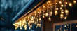 © Nattadesh - Warm festive lights drape elegantly from a snowy roof, creating a cozy winter atmosphere during the holiday season.