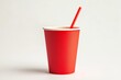 © Mitya - Isolated red paper cup with a straw on a clean white background for photography display purposes.