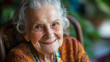 © Elnare - An elderly woman with a warm smile and kind eyes looks at the camera.