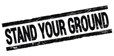 Wall Mural - STAND YOUR GROUND text on black rectangle stamp sign.