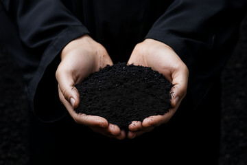 a close-up of two hands gently cradling rich black soil, symbolizing agriculture, growth, and sustai