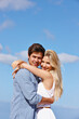 © Leffy/peopleimages.com - Blue sky, portrait or couple hug with smile or love on vacation, valentines day or holiday. Happy, anniversary or people on weekend for bonding together on outdoor romantic trip or date in Greece