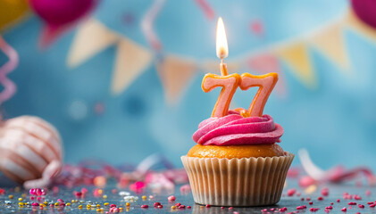 Birthday cupcake with burning lit candle with number 77. Number seventy-seven for seventy-seven years or seventy-seventh anniversary.