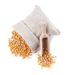 Sticker - Fresh corn kernels, overturned burlap sack and wooden scoop isolated on white, top view