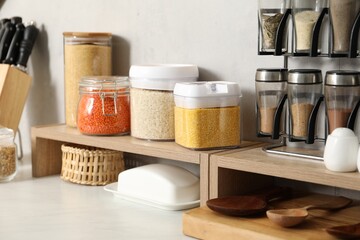 Canvas Print - Different types of cereals and legumes in containers on light marble table