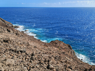 Sea foam and Atlantic Ocean waves crashing against the rocks in Costa Teguise Lanzarote Spain