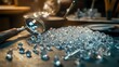 © Suphawan - A pile of glittering diamonds on a jewelers worktable, with precision tools and a magnifying glass in the background.