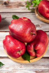 Fresh red delicious apple on wooden table.