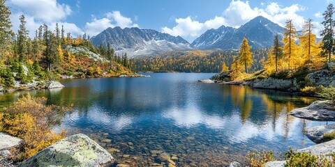 Wall Mural - Tranquil lake surrounded by snow-capped mountains.