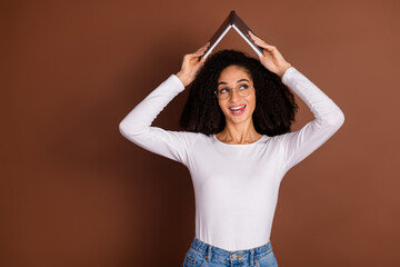 Sticker - Portrait of nice young woman book head look empty space wear pullover isolated on brown color background