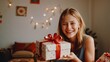 © NewFresh  - Young woman holding a gift box in her hands and smiling. Christmas and New Year concept.