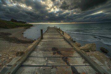 Wall Mural - a wooden pier stretches out into the ocean with cloudy skies above