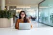 © PRASANNAPIX - young indian woman using laptop at office