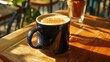 © Alexander - Delightful hot latte in a navy mug at a local coffee shop in sunny miami beach