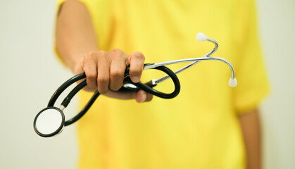 Asian female doctor holding stethoscope in hand