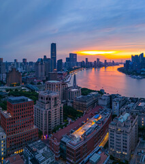 Aerial view of modern city skyline and buildings at sunrise in Shanghai