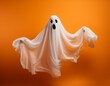© namdarcreative - Floating white Ghost on orange background, Halloween concept