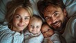 © Feeney - top view of family lying in bed with kids and newborn baby perfect moment strong family bonding and parents unconditional love for their children