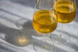 © RooM The Agency - Close-up of two glasses of Traditional Georgian Kisi white wine on a table in sunlight
