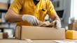 © nuupucca - Warehouse worker packing items into a cardboard box
