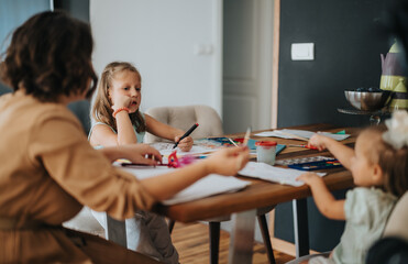 A mother and her two young daughters engage in creative activities at a wooden table, illustrating family togetherness and bonding through art and play in a cozy home setting.