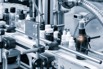 Wall Mural - pharmaceutical industry, medicine pills are filling in the  bottle on production line machine conveyor at the medical factory. selective focus.