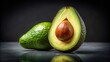 © suchetpong - Isolated whole and half avocado on dark background low angle