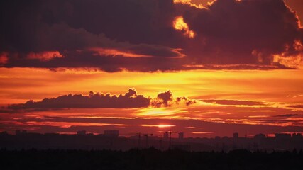Wall Mural - Sunset over city skyline with orange and red clouds. Landscape, timelapse. Evening and nature concept for design and print