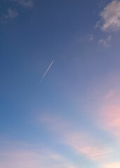 the sunset with a jet aircraft flying on the sky 