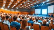 © angel_nt - Attendees actively participate in a business conference held at a contemporary venue, focused on presentations being shown on multiple screens