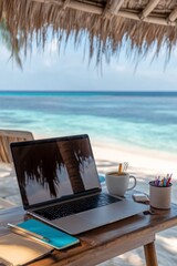 Wall Mural - Relaxing workspace by the beach with a laptop, coffee, and office supplies on a sunny day